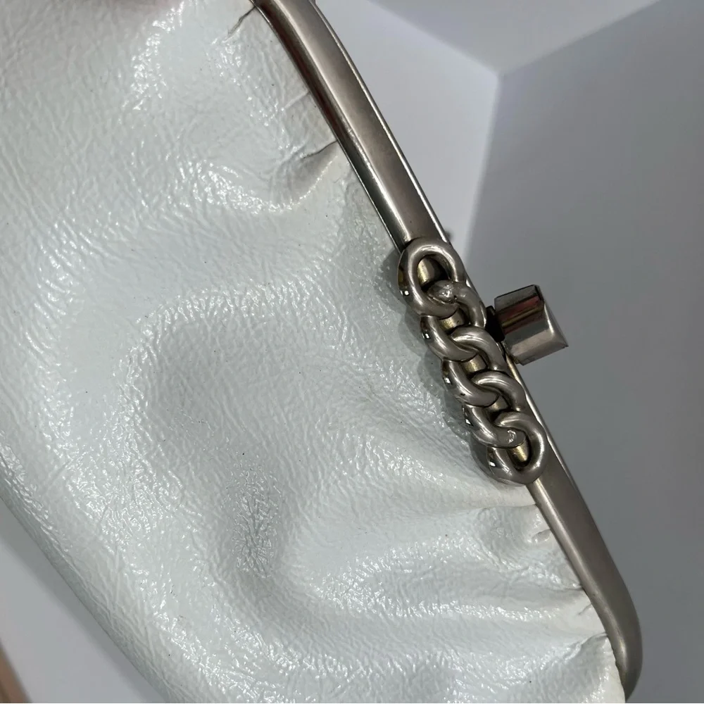 Vintage pair of white leather clutches, one is 70’s with great blk/white lining